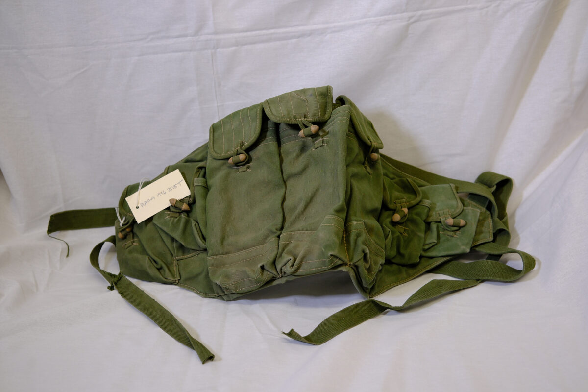 An Iraqi canvas carrying webbing pouch for magazines that can fit across the chest An Iraqi canvas carrying webbing pouch for magazines that can fit across the chest