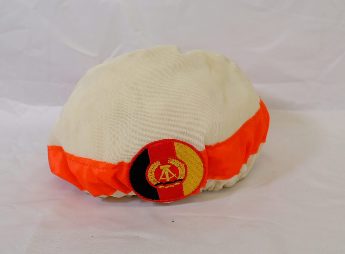 White cap with orange band and logo White cap with orange band and logo