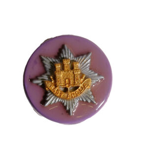 East Anglia Regiment cap badge and title on a stone. Handcrafted by Mr H George. 