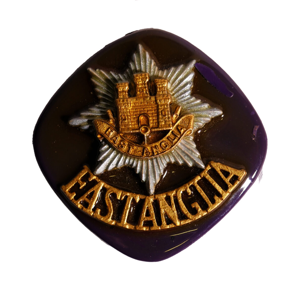 East Anglia Regiment cap badge and title on a stone. Handcrafted by Mr H George. East Anglia Regiment cap badge and title on a stone. Handcrafted by Mr H George.