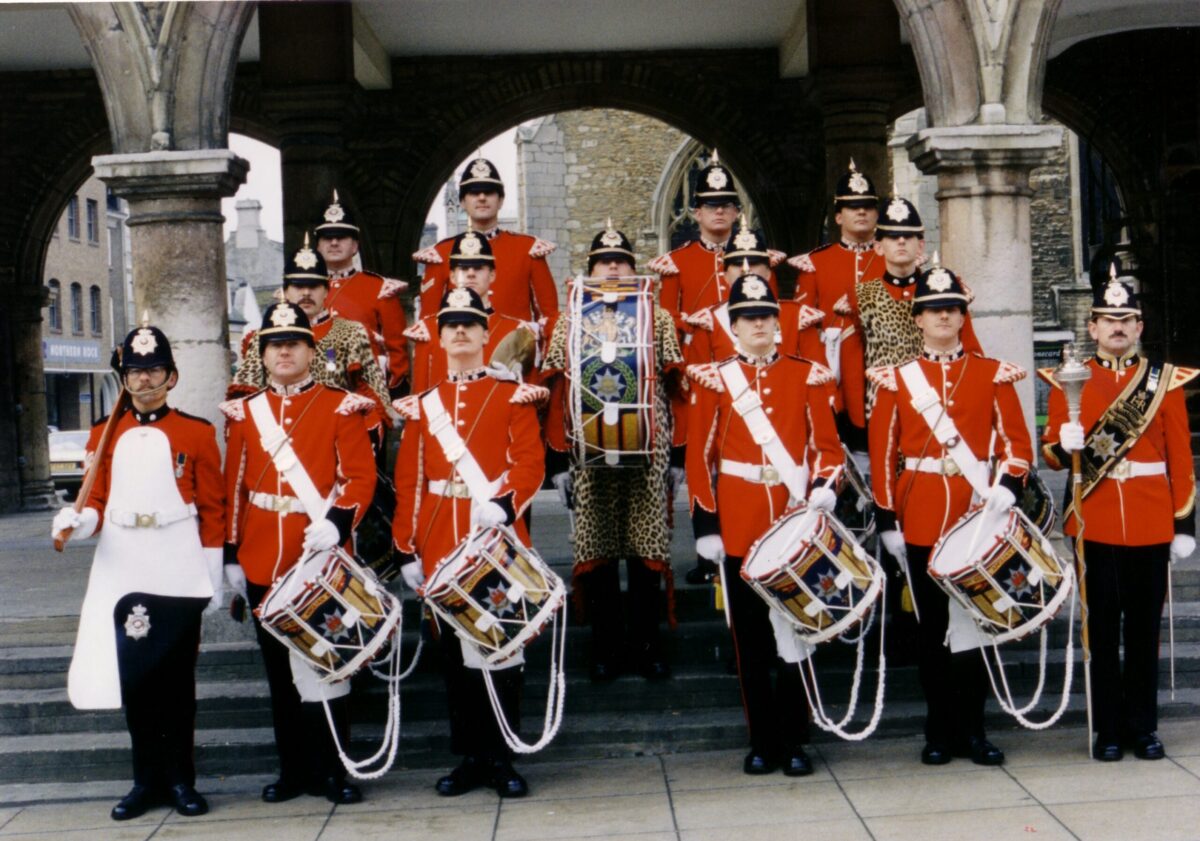 Corps of Drums, 5th Battalion, Remembrance Day, Peterborough, 1991 The Corps of Drums are wearing Full Dress ceremonial uniform. The Drum Major (bottom row, far right) is holding his ceremonial mace. The soldier on the bottom row, far left is the Pioneer Sergeant who wears an apron and carries an axe on ceremonial occasions.
