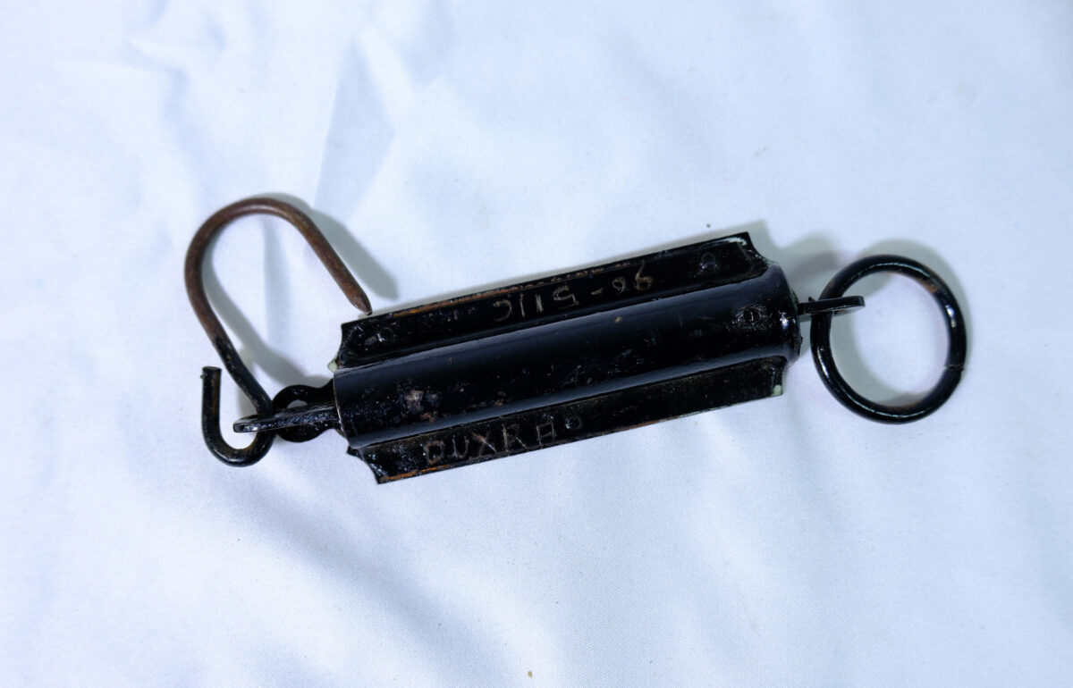 Spring Balance Pocket Scale, a portable hanging spring scale traditionally used for weighing items like mail, fish, or luggage